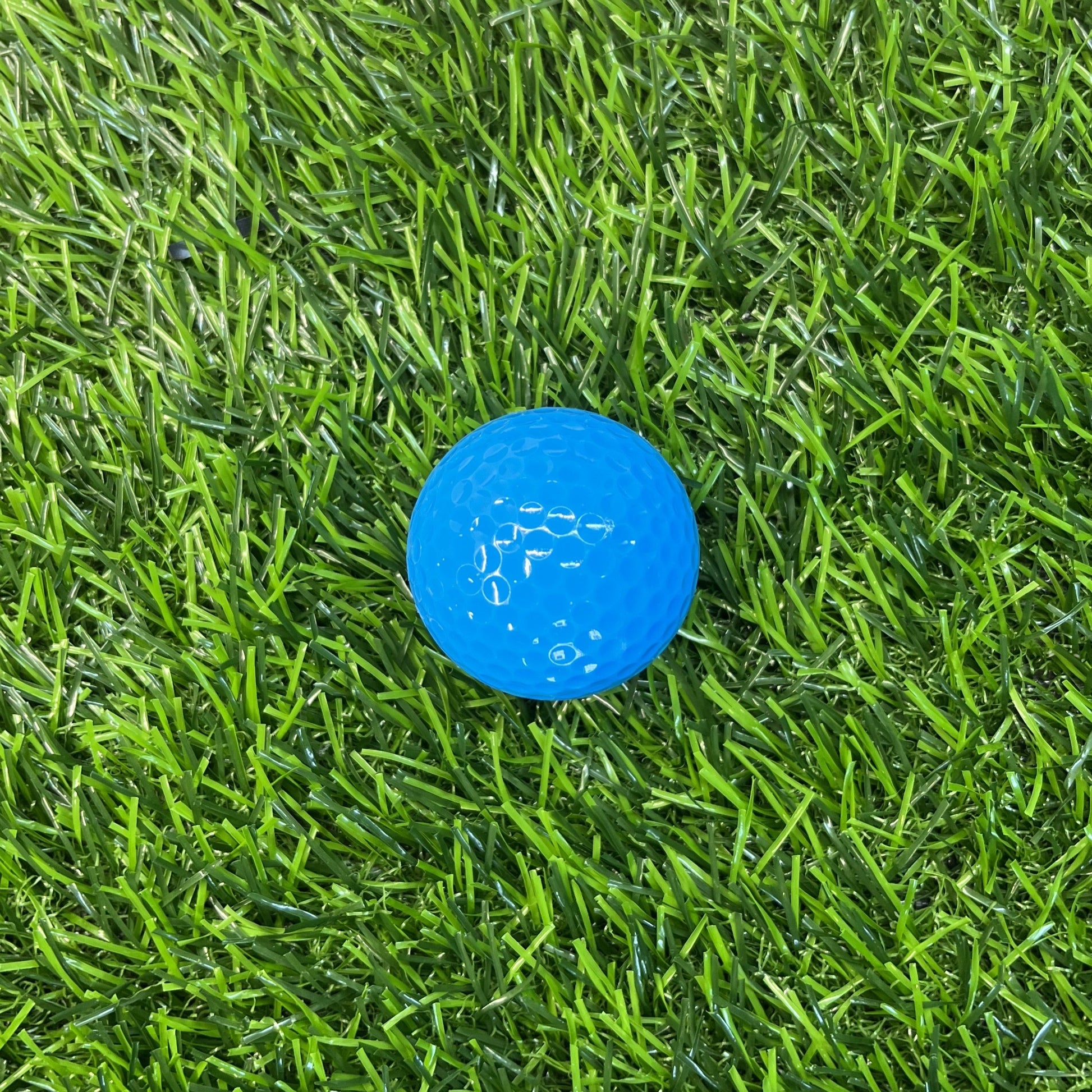 Non branded Blue golf ball blank on grass background