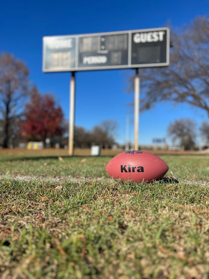 Customized Wilson NFL MVP Football with Custom Text in Black on Grass Background