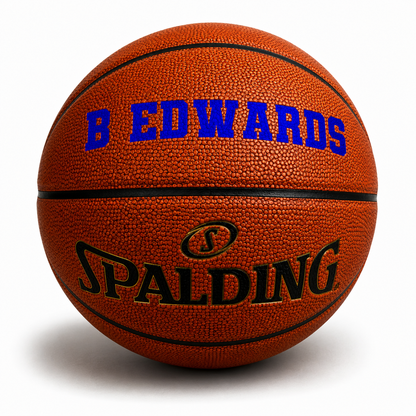 Customized Spalding TF500 Indoor Outdoor Game Ball with custom text written on the top panel in royal blue color.