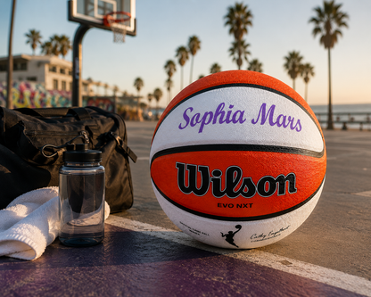Lifestyle image of a customized WNBA Official Game Basketball with custom text written on the top panel.